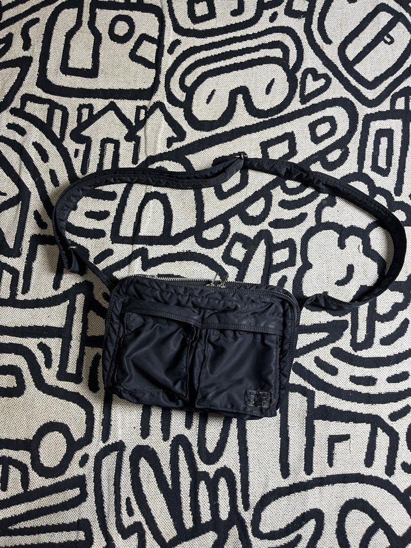 Porter Tanker Black Shoulder Bag (Category: Sling Bags) located in Silang. Submitted by yusthrift (Listing ID 1468175201, Image 1). Description: - Authentic Porter Tanker shoulder bag - Color: Classic black nylon with signature bright orange inner lining - Storage: Dual front snap-button pockets and clear inner zip compartments - Hardware: Heavy-duty metal zippers with Porter branding and adjustable black strap - Condition note: Front woven brand
