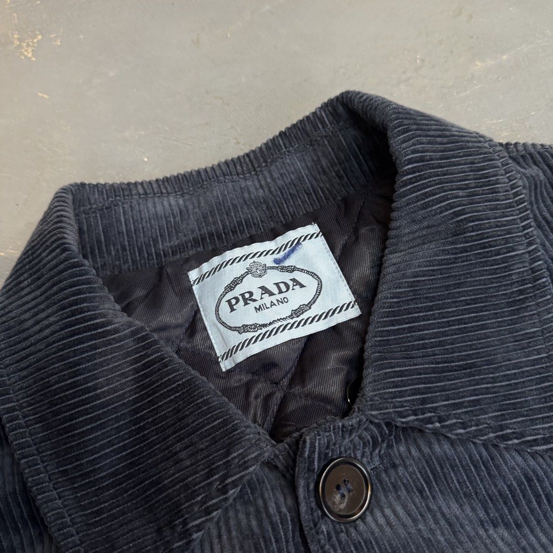 Prada Black Corduroy Quilted Jacket Size S (Category: Coats, Jackets and Outerwear) located in Legazpi City. Submitted by keantuttt (Listing ID 1468136466, Image 2). Description: - Authentic Prada corduroy jacket - Size: S - Color: Classic Black - Warm quilted inner lining for extra comfort - Front button closure with chest and lower flap pockets - Iconic Prada metal triangle logo badge on left chest pocket - Heavy, premium ridged corduroy textur