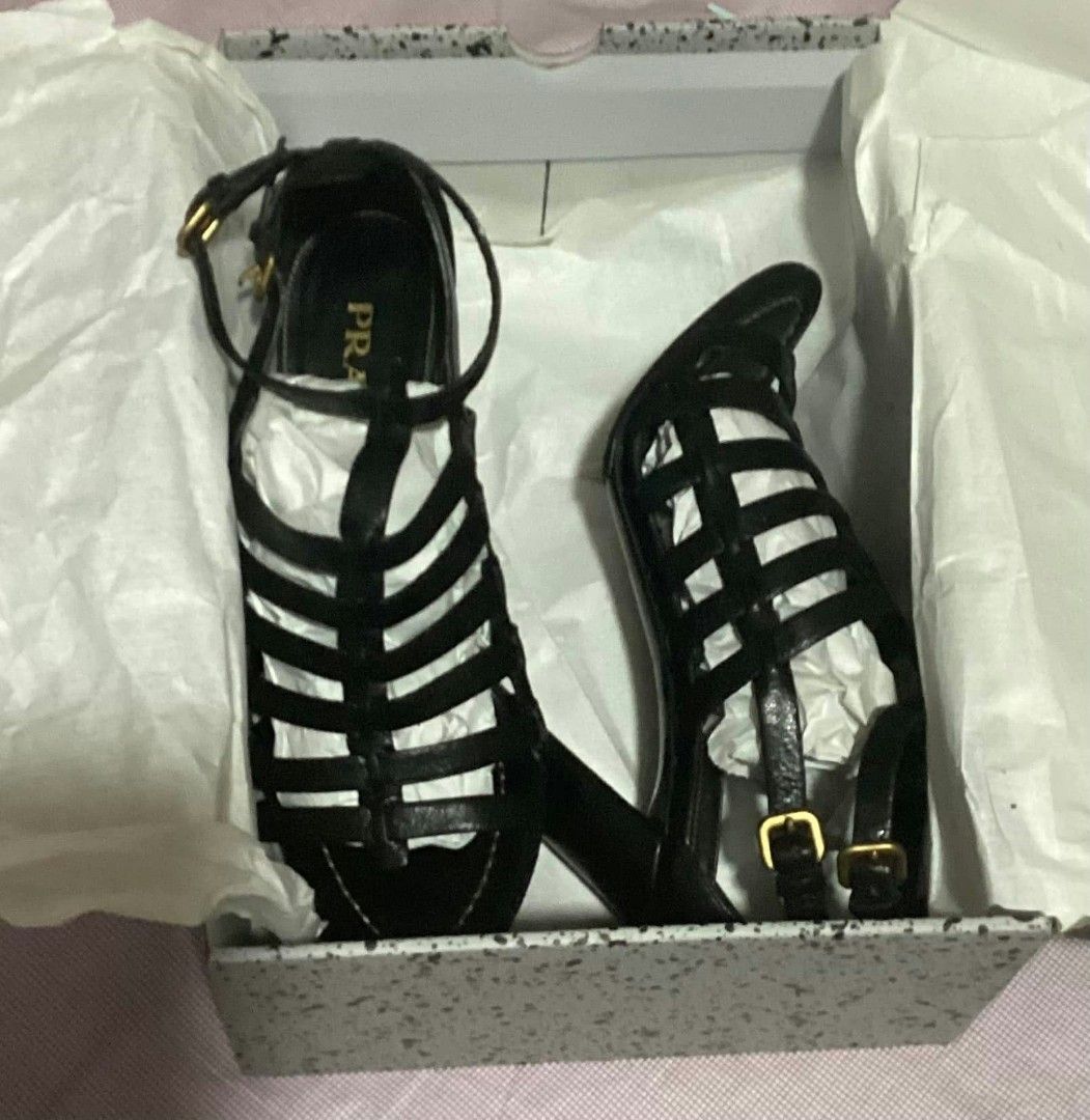 Prada Black Leather Gladiator Sandals Heels Size 37 (Category: Flats & Sandals) located in Paranaque City. Submitted by calm_youngstore7 (Listing ID 1468236766, Image 1). Description: PRADA GLADIATOR CAGE HEELS - Brand: Prada - Style: Black leather gladiator heels / strappy cage design with ankle buckle closures - Heel: Chunky block heel for stability and comfort - Size: 37 (stamped on leather sole) - Inclusions: Original box and tissue paper pac
