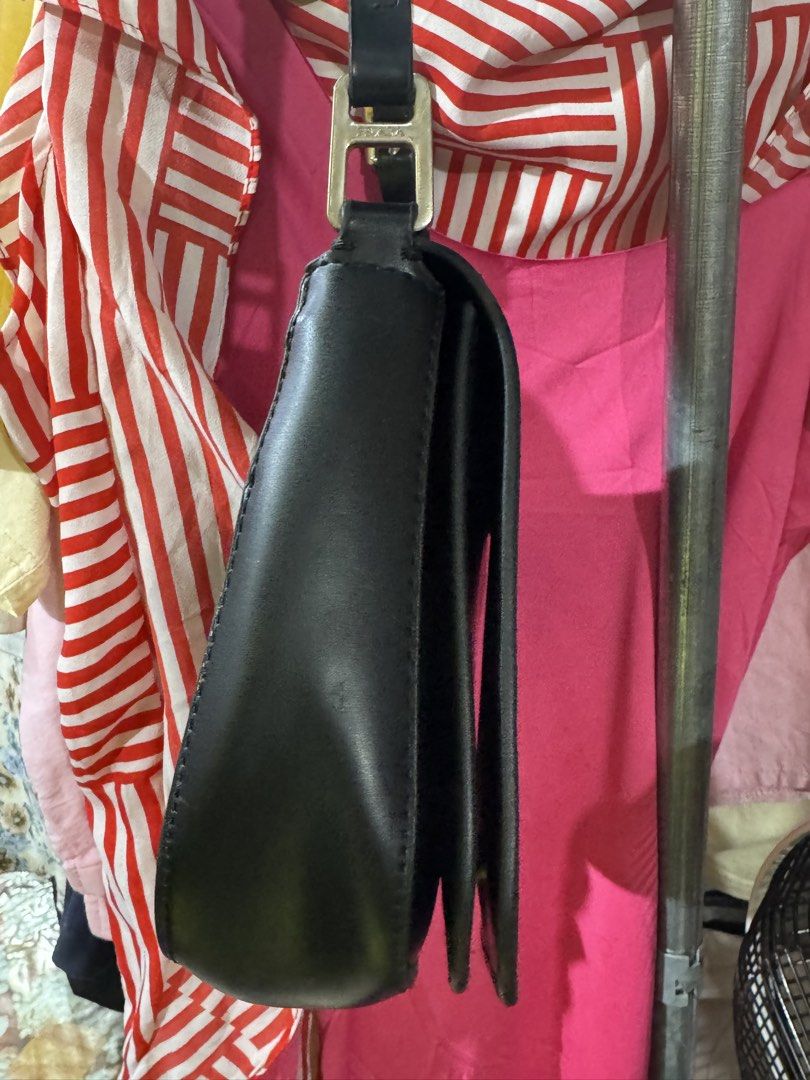 Prada Black Leather Shoulder Bag (Category: Luxury Bags & Wallets) located in Manila. Submitted by wildbear.e10374 (Listing ID 1468187786, Image 3). Description: - Authentic black leather Prada shoulder bag - Secure flap closure with iconic metal triangle logo plaque - Adjustable black leather strap with sleek hardware - Spacious interior with multiple compartments - Clean, minimal design that matches any outfit - Condition: Excellent / Well-main