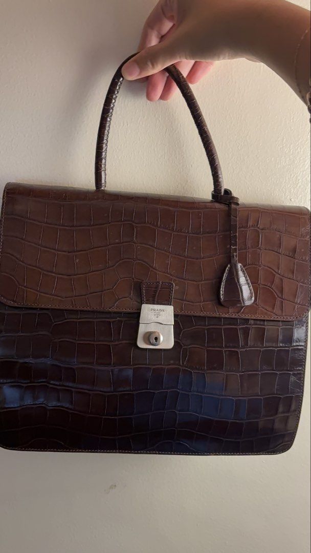 Prada Brown Crocodile Leather Handbag (Category: Luxury Bags & Wallets) located in Marikina City. Submitted by adalol (Listing ID 1468069473, Image 3). Description: - Authentic vintage Prada brown crocodile-embossed leather handbag - Structured top handle design with a secure silver-tone metal clasp closure (Prada Milano engraved) - Features deep green nylon fabric gussets - Comes with the matching clochette key holder - Clean exterior leather te