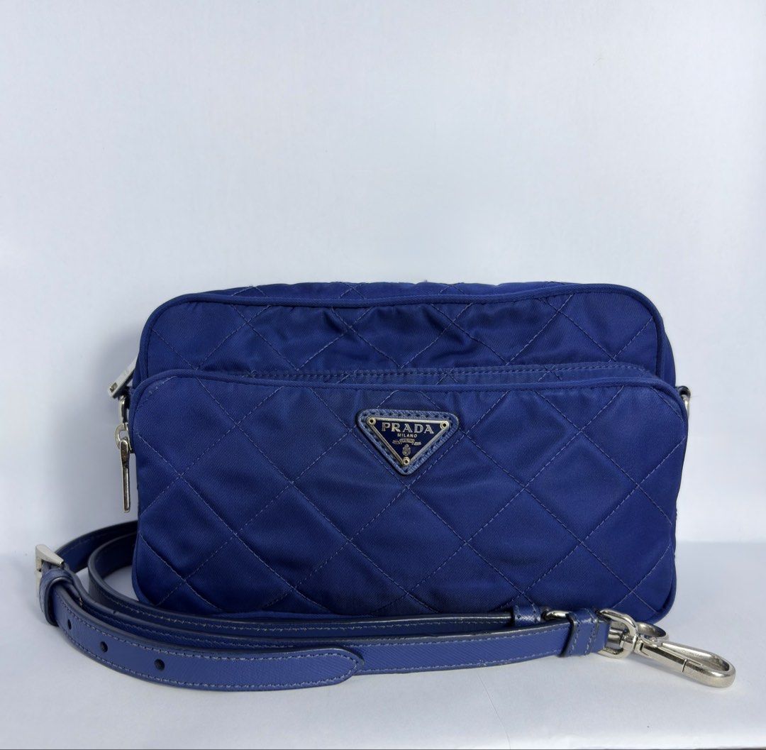 Prada Camera Bag (Category: Luxury Bags & Wallets) located in Pasig City. Submitted by fjrd_relovedluxury28 (Listing ID 1468141121, Image 1). Description: Navy Blue quilted nylon Blue saffiano leater strap Silver hardware Detailed pics available upon request.