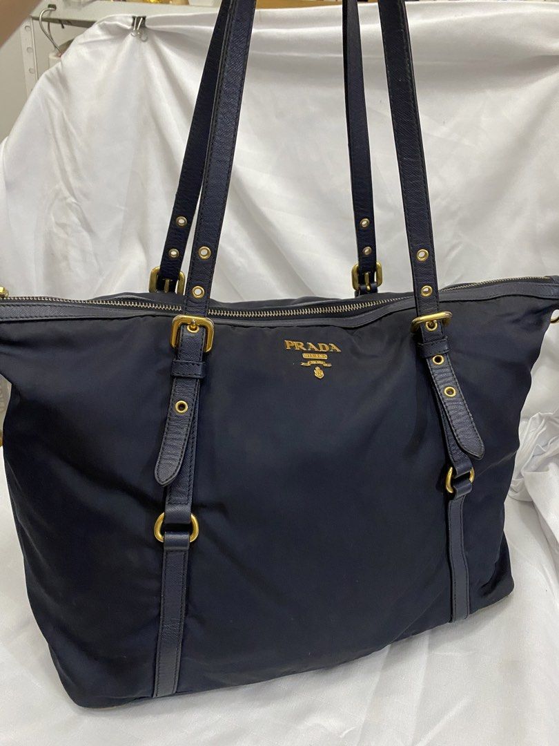 Prada Nylon Tote Bag Navy Blue (Category: Luxury Bags & Wallets) located in Manila. Submitted by grandowl_5653cd (Listing ID 1468246227, Image 1). Description: - Prada Nylon Tote in a rare dark navy blue shade - Luxurious gold-tone hardware and smooth Riri zippers.