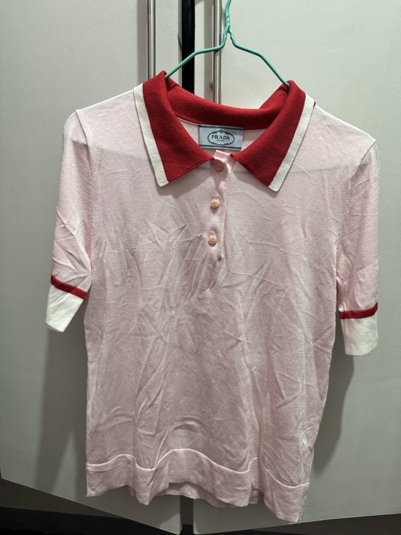 Prada Pink Silk Polo Shirt (Category: Shirts) located in Rosales. Submitted by thriftingismygame (Listing ID 1468169431, Image 3). Description: - Brand: Prada - Item: Silk knit polo shirt - Color: Light pink with red and white collar and sleeve cuffs - Details: Three-button front placket with matching pink buttons, classic fit - Condition: Clean, worn a few times, excellent closet-kept condition - Perfect for smart-casual wear or elevated everyda