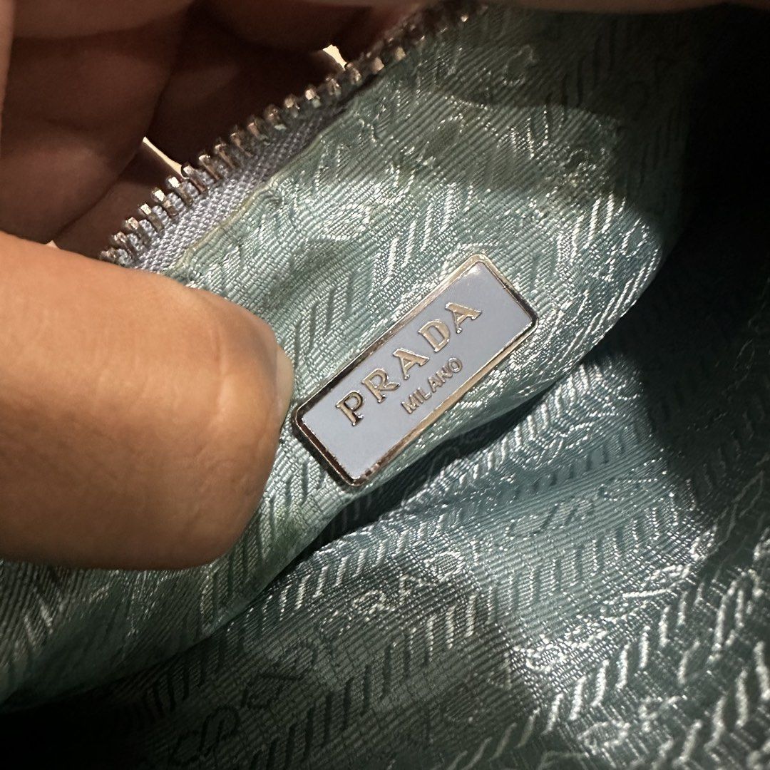 Prada Ruched Nylon Shoulder Bag Light Blue (Category: Luxury Bags & Wallets) located in Quezon City. Submitted by retroboominwantsummoh (Listing ID 1468255469, Image 3). Description: - Prada shoulder bag in gorgeous light blue ruched nylon - Shiny silver-tone hardware with smooth Lampo zipper closure - Classic Prada metal triangle logo on the front - Interior lined with signature Prada logo fabric - Includes Milano metal plaque tag and "Made in I