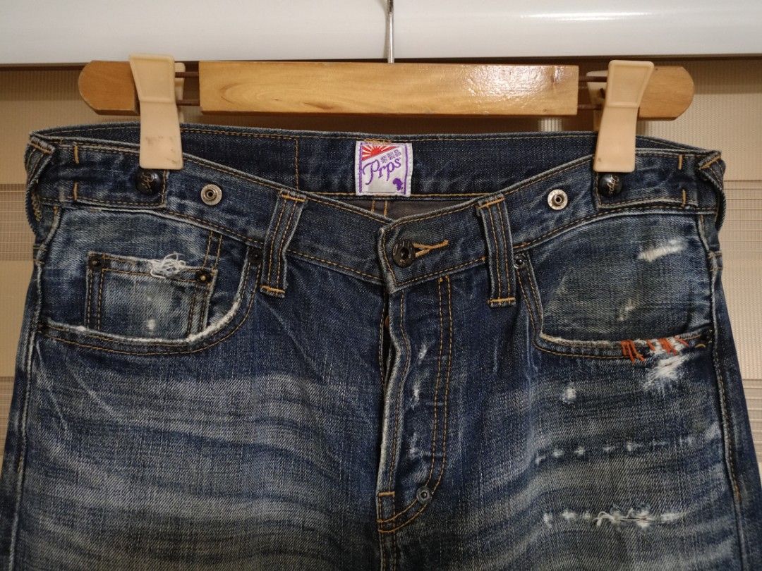 PRPS Noir "Rambler" Slim Straight Jeans (Category: Jeans) located in Valenzuela. Submitted by One.Only.Nan (Listing ID 1468221635, Image 2). Description: PRPS (Purple Tag / "紫製品") distressed denim jeans designed by Donwan Harrell. - Non-selvedge premium denim - Design & Wash: Dark indigo wash with heavy hand-distressing, whiskering, repaired/patchwork details, and signature button-fly construction. - Origin: Crafted in Japan from high-grade denim