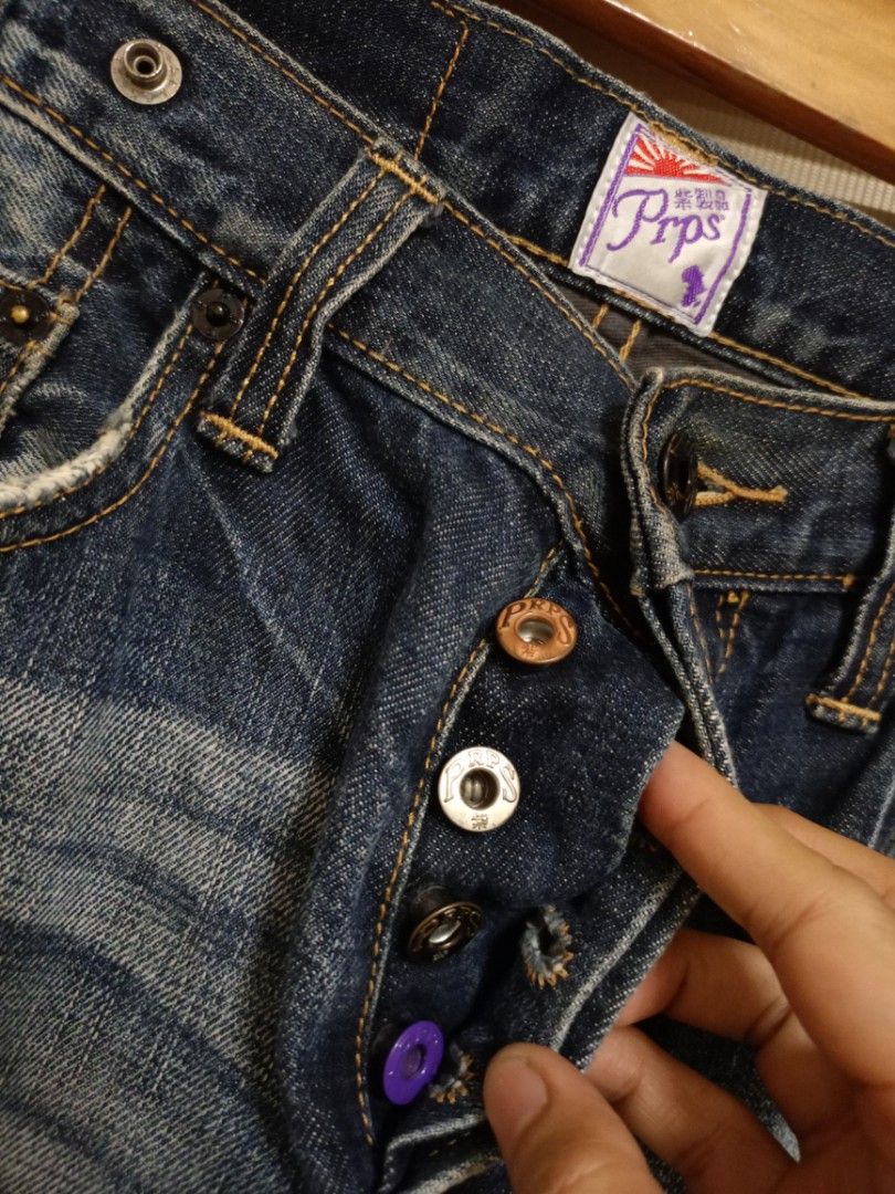 PRPS Noir "Rambler" Slim Straight Jeans (Category: Jeans) located in Valenzuela. Submitted by One.Only.Nan (Listing ID 1468221635, Image 3). Description: PRPS (Purple Tag / "紫製品") distressed denim jeans designed by Donwan Harrell. - Non-selvedge premium denim - Design & Wash: Dark indigo wash with heavy hand-distressing, whiskering, repaired/patchwork details, and signature button-fly construction. - Origin: Crafted in Japan from high-grade denim