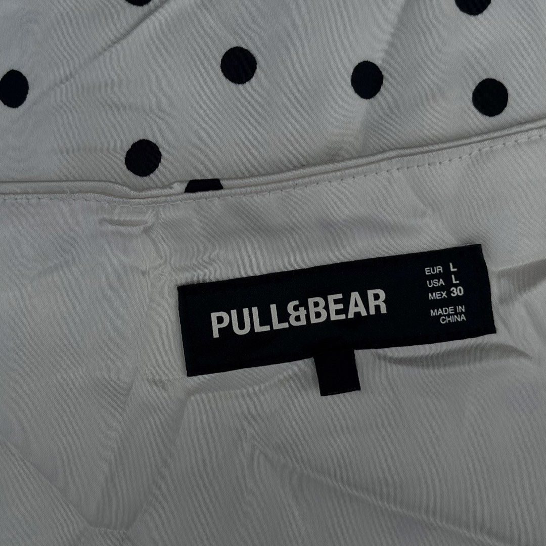 Pull&Bear White & Black Polka Dot Halter with side zipper (Category: Sleeveless) located in Surigao. Submitted by rynryngoaway (Listing ID 1468118122, Image 2). Description: Cute and classy Pull&Bear polka dot halter top 🤍🖤 Features a white fabric with black polka dots, a flattering halter neckline, and a flowy, flared hem. Perfect for casual outfits, summer days, vacations, or a chic Y2K-inspired look! Can fit medium because of china sizing ar