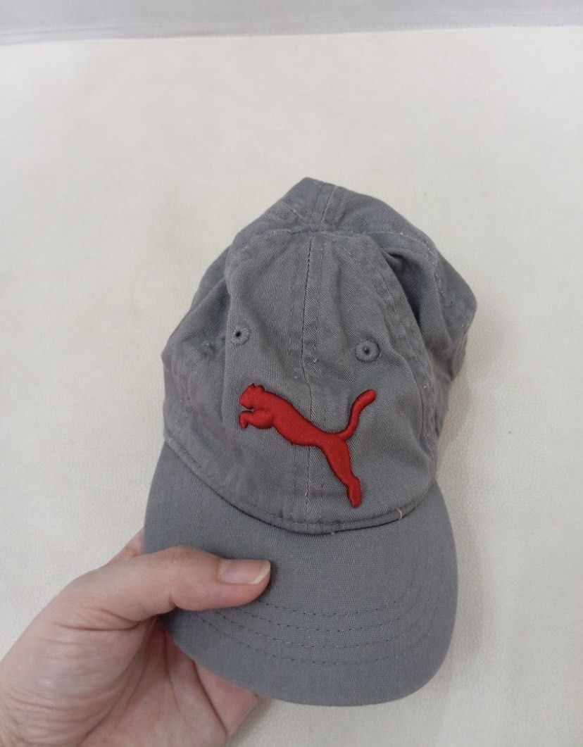Puma Gray Cap with Red Logo (Category: Babies & Kids Fashion) located in Legazpi City. Submitted by iceyag (Listing ID 1468072673, Image 1). Description: - Brand: Puma - Color: Gray with red embroidered leaping cat logo - Size: Infant sizing (refer to inner tags) - Design: Curved brim with stitching and branded interior taping - Style: Classic and casual, perfect for everyday wear.