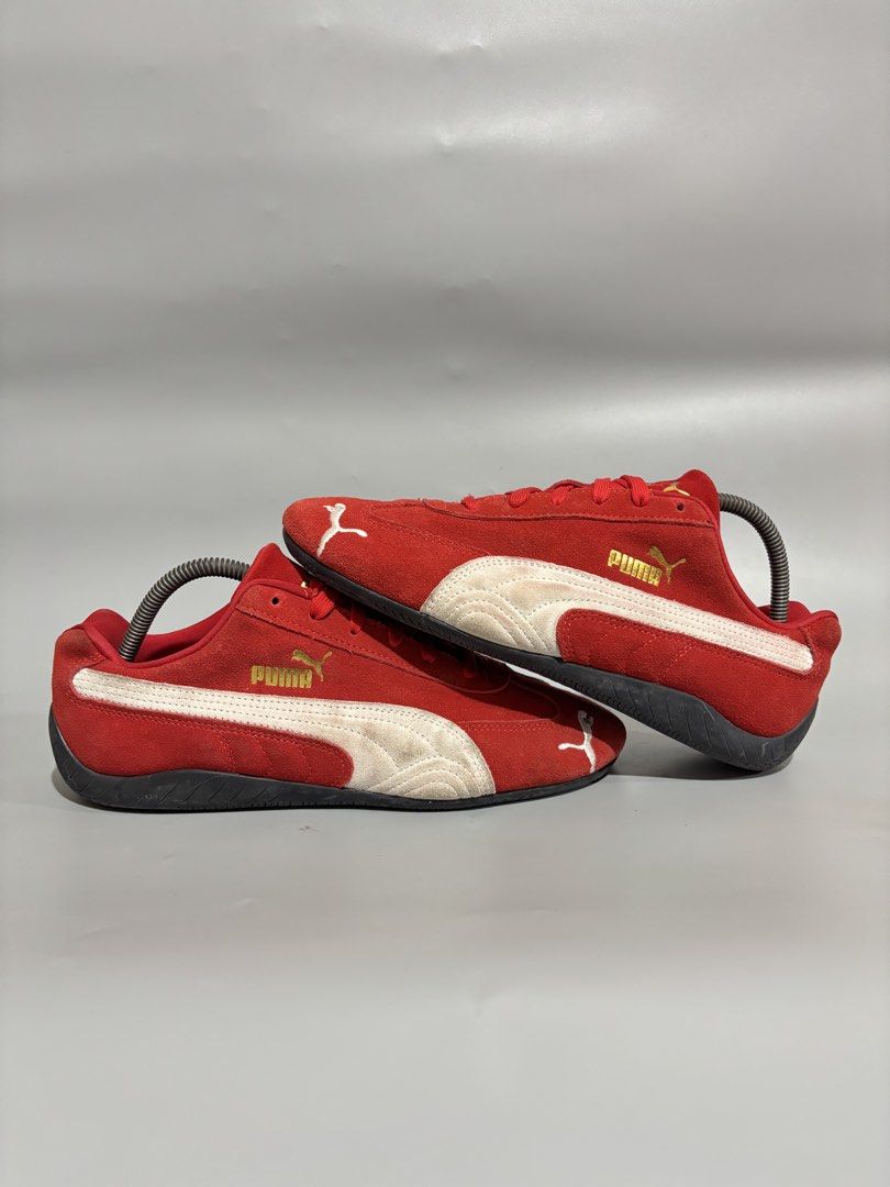 Puma Red White Speedcat Sneakers Size 9 US (Category: Sneakers) located in Butuan. Submitted by shoeetasho (Listing ID 1468212606, Image 2). Description: - Brand/Model: Puma Motorsport Red Suede Sneakers - Size: 9 US / 42 EUR / 27cm - Design: Red suede upper, white side stripes, and gold branding - Outsole: Grippy rubber with unique tire tread pattern and red Puma logos - Inclusions: Standard red laces - Condition: Suede upper shows minor natural