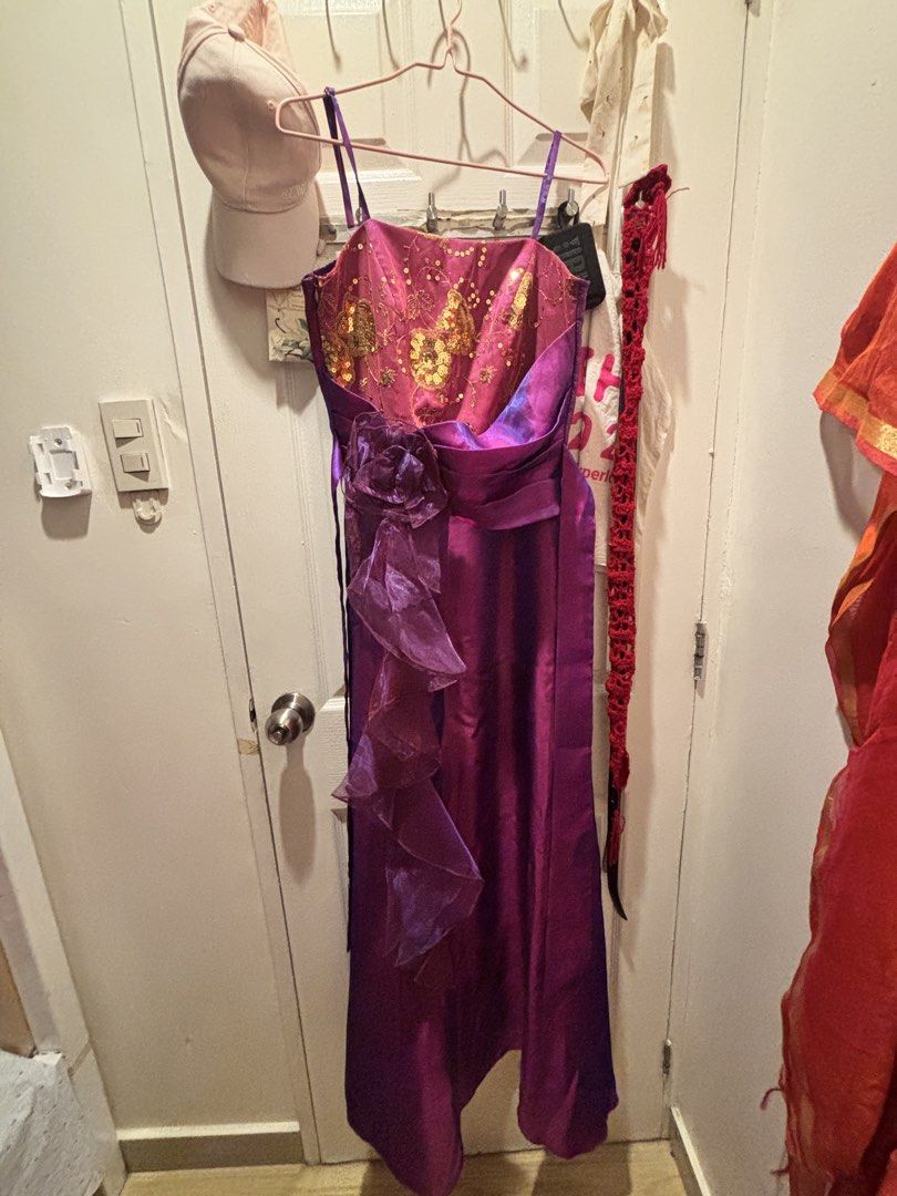Purple floor length dress (Category: Evening dresses & gowns) located in Valenzuela. Submitted by sasha2802 (Listing ID 1468194947, Image 1). Description: - Purple with pink and gold sequin details - Shiny satin-like fabric - Spaghetti straps, lace floral pattern on bodice, ruched back - Full length - worn once for a wedding - decluttering wardrobe.
