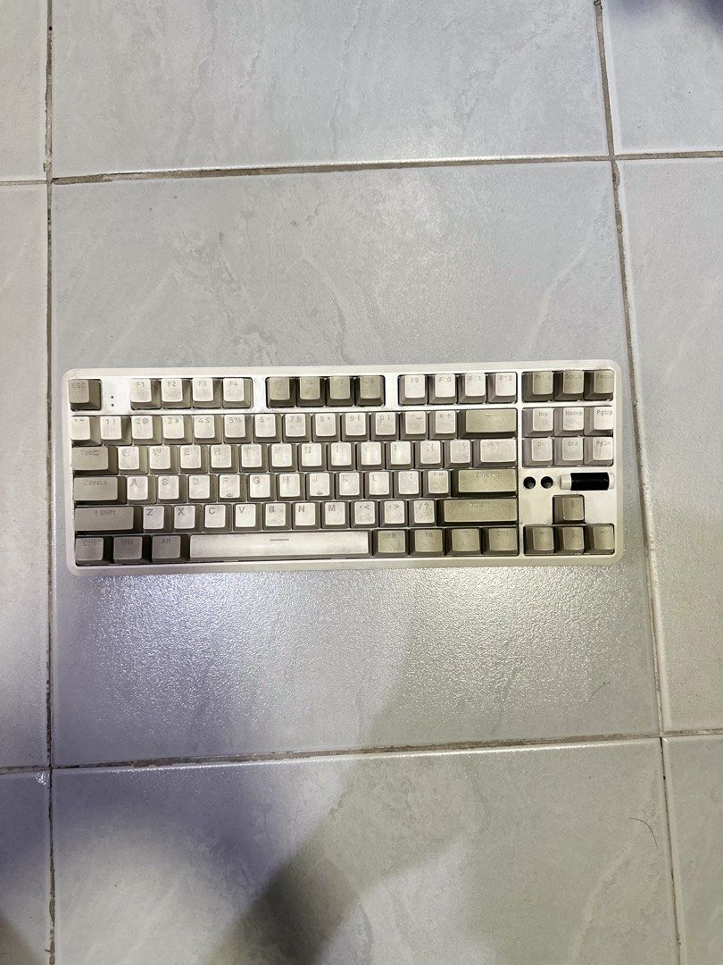 RAKK Lam-Ang Lite Modular TKL Mechanical Keyboard (Category: Computer Keyboard) located in Makati City. Submitted by its.ptrck (Listing ID 1468116573, Image 1). Description: - Model: Rakk Lam-Ang Lite TKL Mechanical Keyboard - Layout: Standard Tenkeyless (TKL) with stylish off-white and grey keycaps - Features: Universal hot-swappable sockets and a handy volume roller wheel on the top right - Condition: Fully functional wired setup; shows minor d