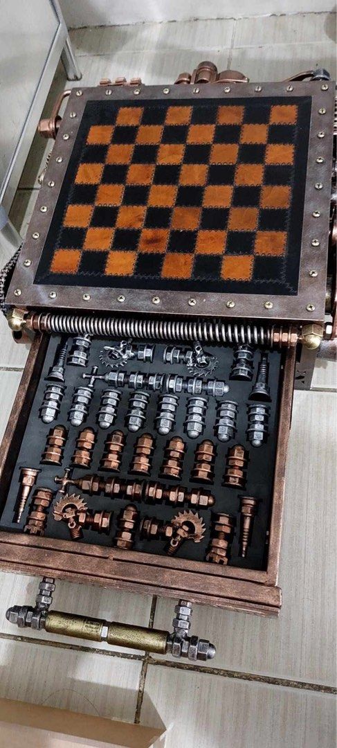 Ram Mallari Steampunk Custom Handmade Chess Set with Storage Drawer (Category: Vintage Collectibles) located in Las Pinas. Submitted by bluemieeeee (Listing ID 1468177546, Image 1). Description: - Custom steampunk chess set with intricate mechanical gears, springs, and textured metal finishes - Leather-look checkered board top with stunning copper-toned accents and distinct hardware - Built-in pull-out storage drawer with custom foam slots to hol