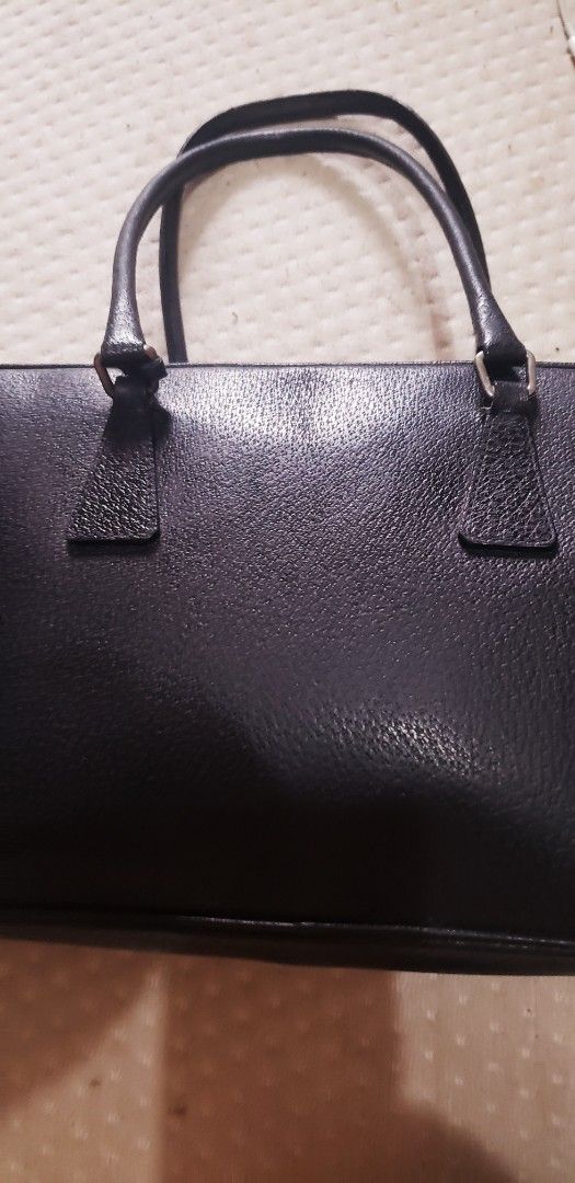 RARE Prada Black Leather Briefcase Handbag (Category: Luxury Bags & Wallets) located in Marikina City. Submitted by racoon143 (Listing ID 1468115370, Image 2). Description: - Material: Premium black textured leather with silver-tone hardware - Design: Structured rectangular shape with clean lines - Features: Secure zipper closure, padlock included, and reinforced top handles - Capacity: Spacious interior for documents and daily essentials - Style