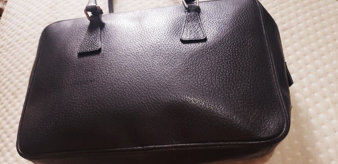 RARE Prada Black Leather Briefcase Handbag (Category: Luxury Bags & Wallets) located in Marikina City. Submitted by racoon143 (Listing ID 1468115370, Image 1). Description: - Material: Premium black textured leather with silver-tone hardware - Design: Structured rectangular shape with clean lines - Features: Secure zipper closure, padlock included, and reinforced top handles - Capacity: Spacious interior for documents and daily essentials - Style