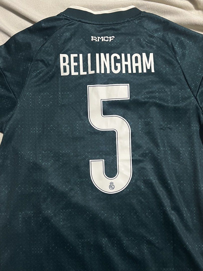 Real Madrid Bellingham 5 Third Jersey 24/25 Size L (Category: Activewear) located in San Pedro. Submitted by d1eub (Listing ID 1468095016, Image 2). Description: - Authentic Real Madrid 24/25 Third Jersey in the striking dark green colorway - Features official Jude Bellingham name and number 5 printing - Styled with the vintage club crest and classic white Adidas Trefoil logo - Equipped with official Champions League patches on both sleeves - Siz