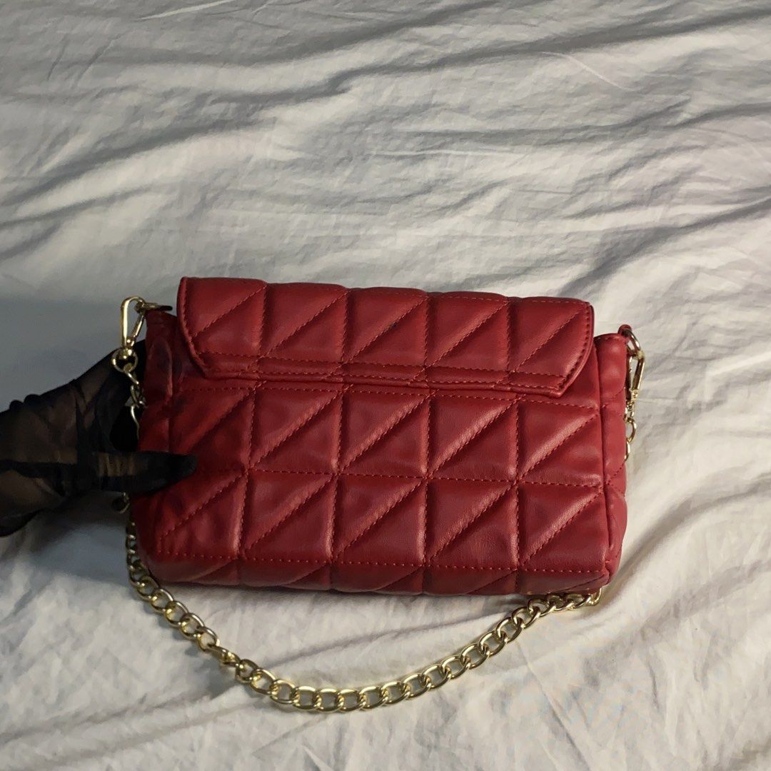 Red Quilted Shoulder Bag with Gold Chain (Category: Luxury Bags & Wallets) located in Quezon City. Submitted by suzue.xen (Listing ID 1468099994, Image 3). Description: - Color: Bright red with chic triangle quilting - Material: Faux leather with dark fabric lining - Hardware: Gold chain strap with lobster clasps - Closure: Snap button under front flap - Interior: Includes one convenient slip pocket - Condition: Clean overall shape, note there ar