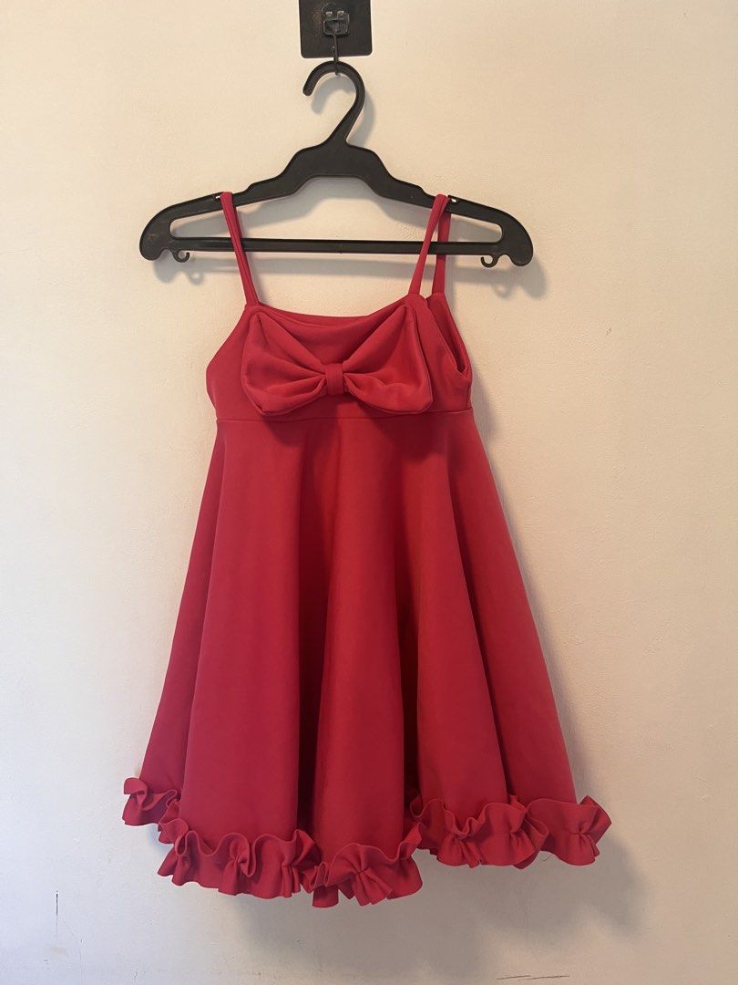 Red Spaghetti Strap Dress with Front Bow and Ruffle Hem (Category: Dresses) located in Manila. Submitted by yliahdreye52249 (Listing ID 1468098132, Image 1). Description: - Color: Bright pink - Style: Spaghetti strap dress with a flared skater skirt and thick ruffled hem - Detail: Large structured bow accent on the front bodice - Condition: Pre-loved with visible dark stains on the lower front section (please check the second photo for reference)
