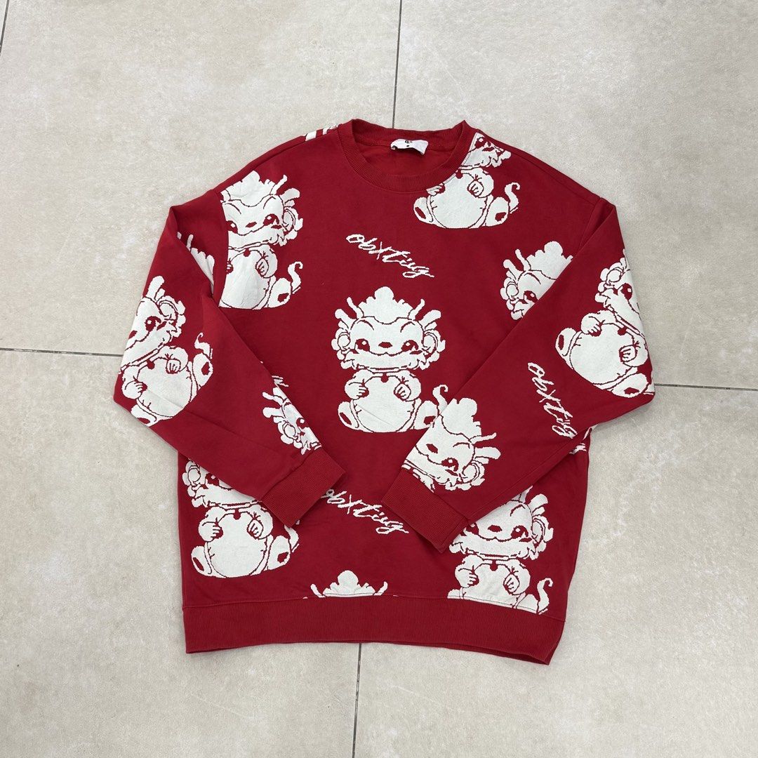 Red White Graphic Print Sweater (Category: Longsleeves) located in Mexico. Submitted by mallarinathalie (Listing ID 1468111945, Image 3). Description: - Color: Bold red with all-over white character and text graphic print - Material: Comfortable knit fabric - Design: Classic crewneck with ribbed cuffs and hem - Style: Standout casual piece, perfect for everyday wear.