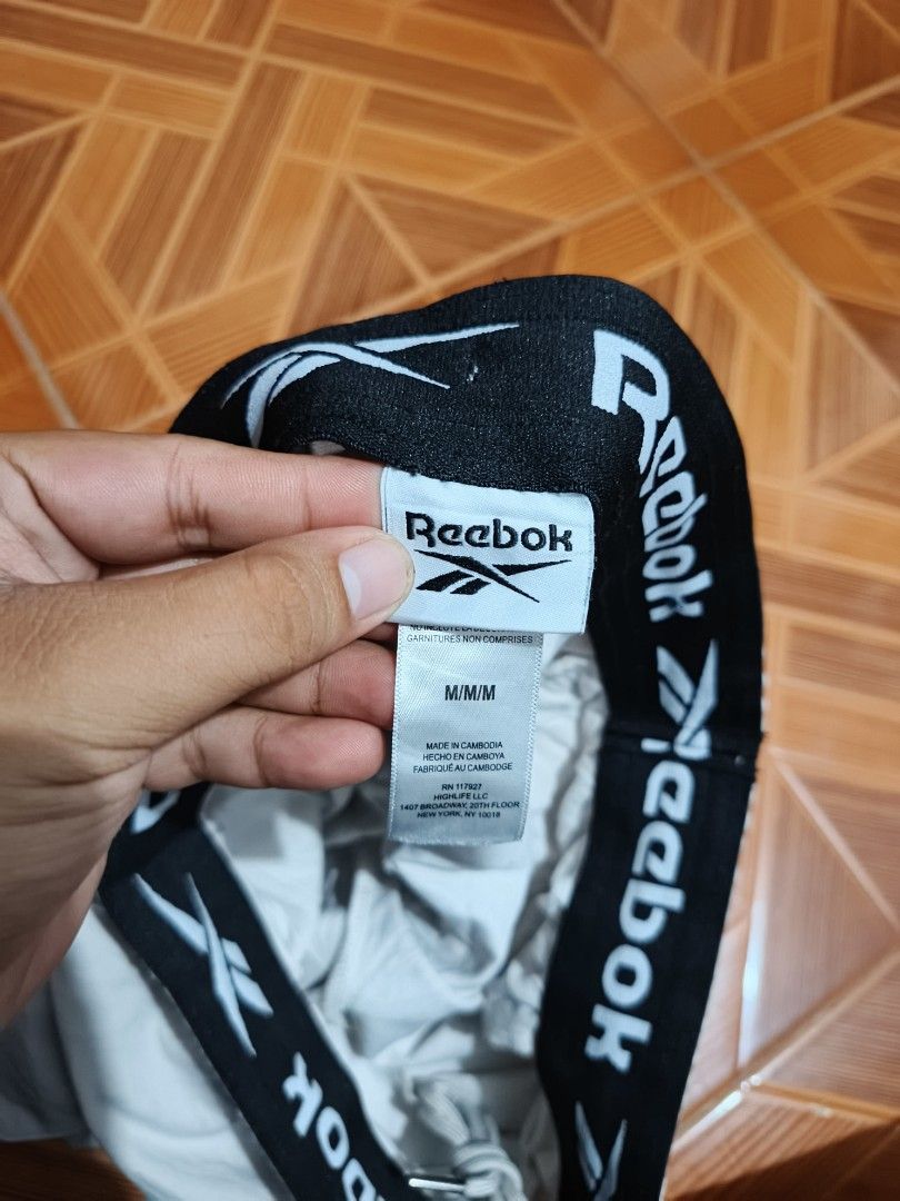 Reebok Cargo Shorts Light Grey Size M (Category: Shorts) located in Manila. Submitted by dyastenthrift (Listing ID 1468163341, Image 3). Description: - Brand: Reebok - Style: Cargo Shorts - Color: Light Grey - Size: Medium - Waistband: Elastic with branded black inner band and adjustable drawstring - Pockets: Large cargo pockets on both legs - Details: Small embroidered logo near the hem - Origin: Made in Cambodia - Condition: Great for casual ev