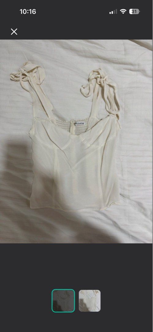 Reformation White Tie Strap Crop Top (Category: Sleeveless) located in Rosales. Submitted by thriftingismygame (Listing ID 1468170585, Image 1). Description: - Brand: Reformation - Color: Classic White - Details: Adjustable tie shoulder straps, sweetheart neckline with structured cups, and a comfy smocked back panel - Fabric: Lightweight and breathable, perfect for PH weather - Styling: Pairs effortlessly with denim jeans, shorts, or skirts - Con