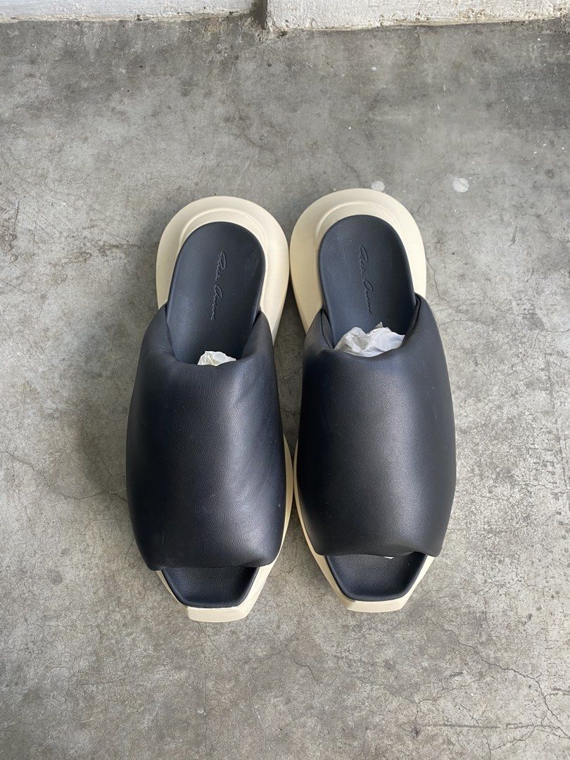 Rick Owens Geth Puffer Slides (Category: Slippers & Slides) located in Cavite. Submitted by benta_bounce (Listing ID 1468077950, Image 2). Description: - Brand: Rick Owens - Style: Padded slides / slip-on - Color: Black leather upper with milk white sole - Sole: Distinctive thick shark tooth design - Branding: Debossed signature on footbed and outsole - Details: Structured puffed upper strap - Condition: like new, unworn, zero wear on soles, pape