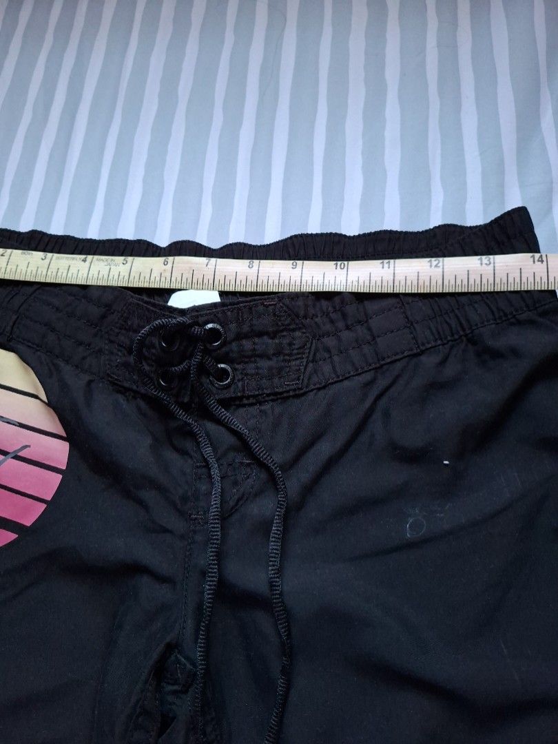 Rip curl board shorts (Category: Bikinis & Swimsuits) located in Binangonan. Submitted by anjiscloset (Listing ID 1468071055, Image 3). Description: - Brand: Rip Curl - Color: Classic Black - Material: 100% lightweight polyester (easy to wash) - Waistband: Elastic with trendy ruffled detailing - Origin: Made in China tag intact - Condition: Excellent, ready to wear.