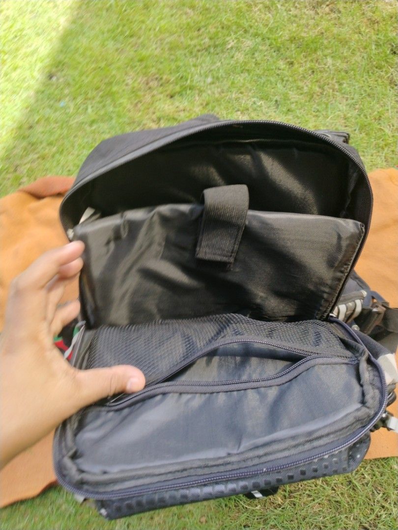 Rockbiker Camouflage Riding Motorcycle Backpack (Category: Backpacks) located in Legazpi City. Submitted by genobecollectives (Listing ID 1468080481, Image 3). Description: - Brand: Rockbiker - Design: Black and camo color scheme with safety reflective strips on straps - Storage: Multiple zippered compartments, interior padded laptop sleeve, and mesh pocket - Comfort: Mesh padded back panel and sturdy front buckle closure - Condition: Clean insid