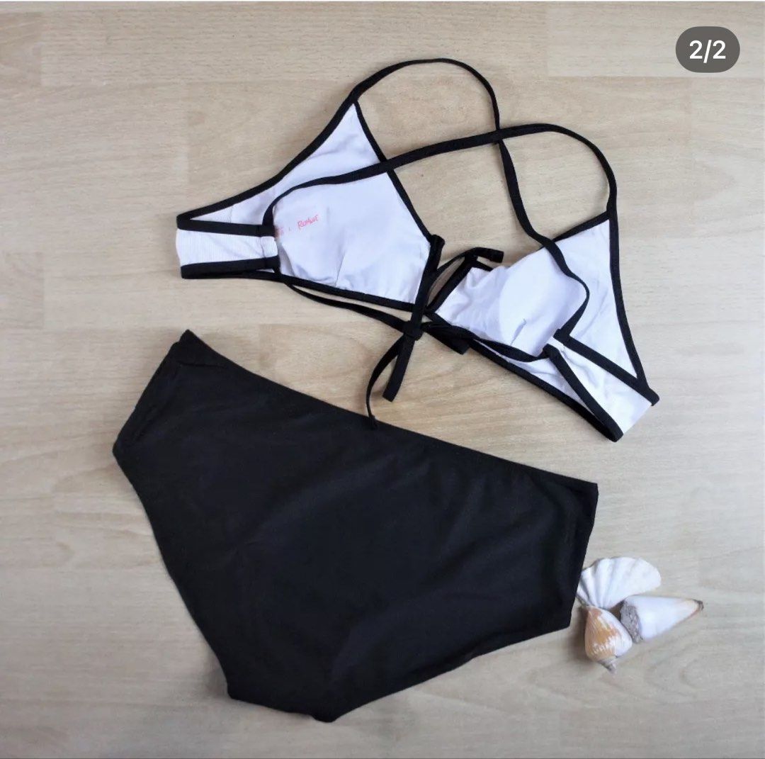 Romwe Black and White Two-Piece Bikini Size L (Category: Bikinis & Swimsuits) located in Bulacan. Submitted by peach1025 (Listing ID 1468065027, Image 2). Description: - Brand: Romwe - Type: Two-piece bikini set - Size: L (tag attached) - Top: White ribbed with black trim and crossover back straps - Bottoms: High-waisted black - Material: 82% polyester, 18% spandex - Care: Hand wash separately - Origin: Made in China.