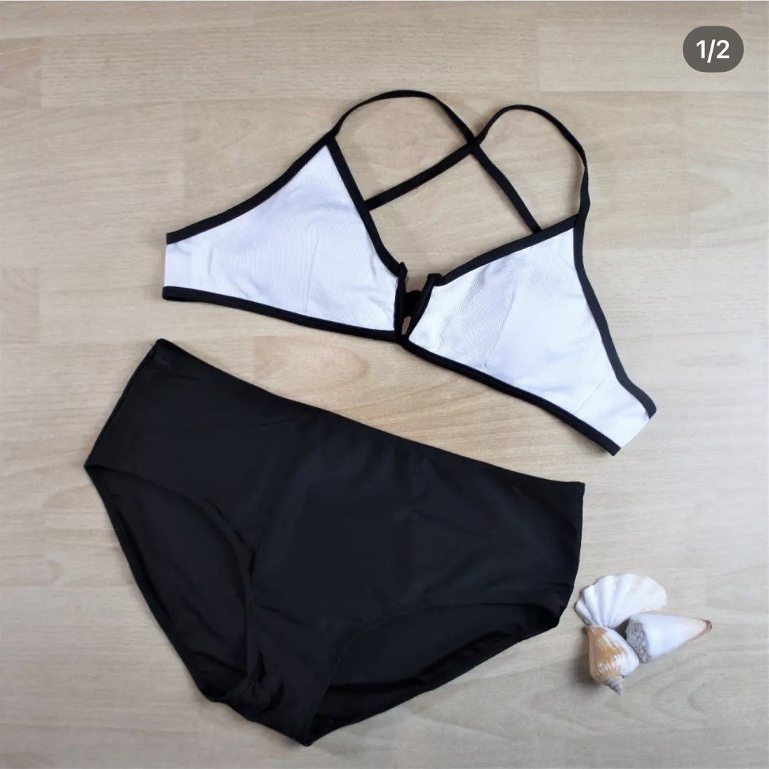 Romwe Black and White Two-Piece Bikini Size L (Category: Bikinis & Swimsuits) located in Bulacan. Submitted by peach1025 (Listing ID 1468065027, Image 1). Description: - Brand: Romwe - Type: Two-piece bikini set - Size: L (tag attached) - Top: White ribbed with black trim and crossover back straps - Bottoms: High-waisted black - Material: 82% polyester, 18% spandex - Care: Hand wash separately - Origin: Made in China.