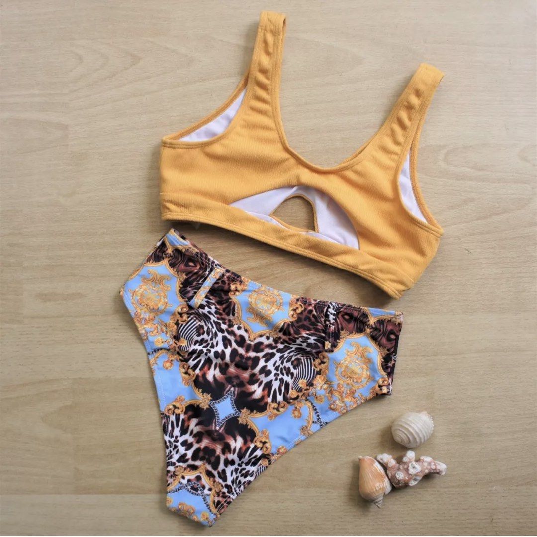 ROMWE Yellow and Blue Leopard Print Bikini Set Size M (Category: Bikinis & Swimsuits) located in Bulacan. Submitted by peach1025 (Listing ID 1468111175, Image 2). Description: - Brand/Style: ROMWE two-piece swimsuit - Size: Medium (tag attached) - Top: Ribbed mustard yellow crop top with front cutout - Bottoms: High-waisted with blue, gold baroque, and leopard print - Lining: Fully lined white interior - Condition: Brand new with tags, great for 