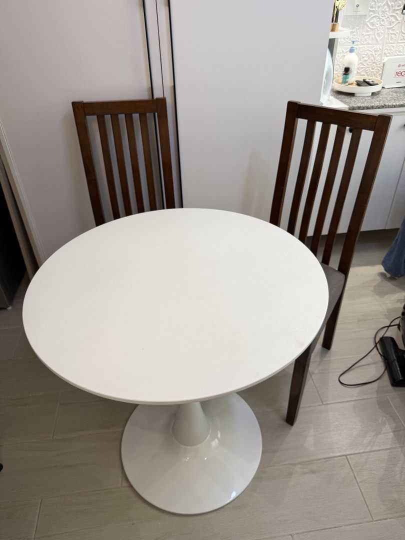 Round dining table & 2 chairs (Category: Tables & Sets) located in Marikina City. Submitted by lar.luxury (Listing ID 1468078911, Image 1). Description: - 3-piece dining set: round white tulip table and 2 chairs - Dark wood chairs feature comfortable grey padded fabric seats and slatted high backs - Compact and space-saving design, ideal for small kitchens or breakfast nooks - Modern aesthetic that fits well with various interiors - Condition: Go