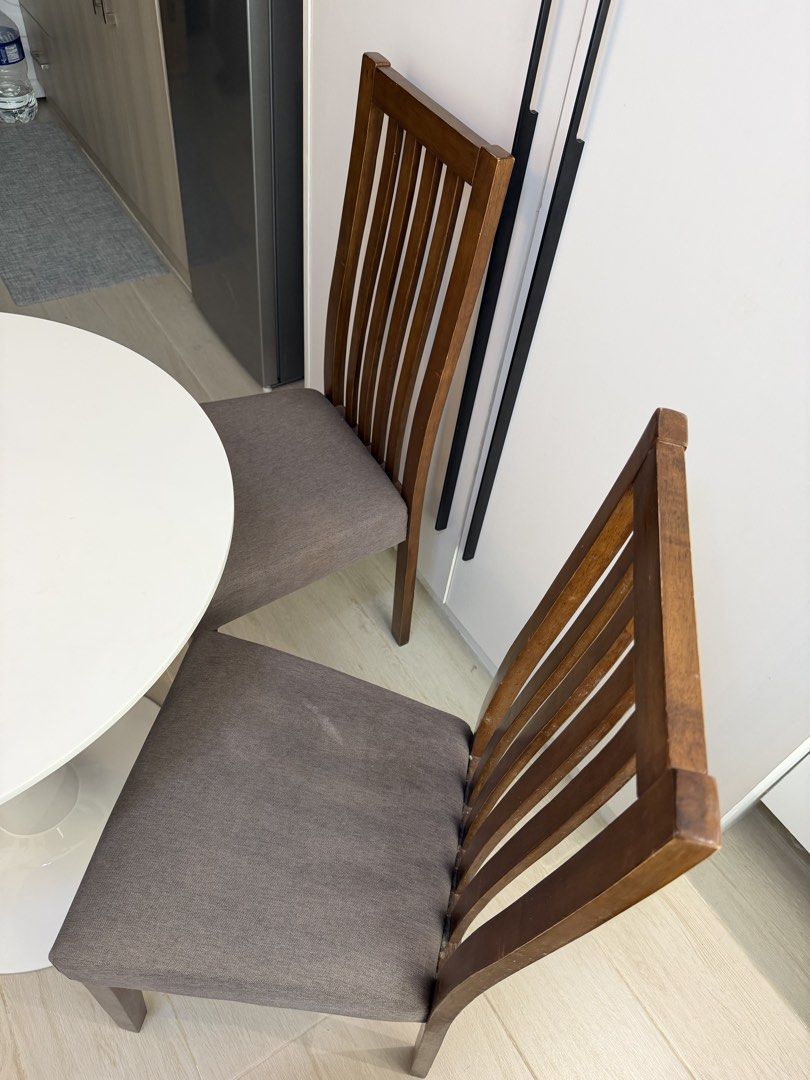 Round dining table & 2 chairs (Category: Tables & Sets) located in Marikina City. Submitted by lar.luxury (Listing ID 1468078911, Image 2). Description: - 3-piece dining set: round white tulip table and 2 chairs - Dark wood chairs feature comfortable grey padded fabric seats and slatted high backs - Compact and space-saving design, ideal for small kitchens or breakfast nooks - Modern aesthetic that fits well with various interiors - Condition: Go