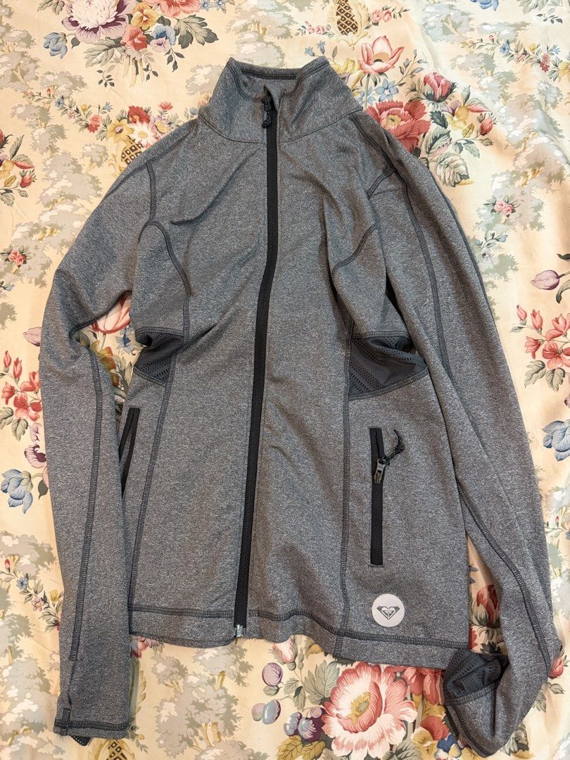 Roxy Grey Athletic Zip-Up Jacket (Category: Coats, Jackets and Outerwear) located in Manila. Submitted by bellafleur (Listing ID 1468196757, Image 1). Description: Grey Roxy athletic zip-up jacket in size XS. Breathable mesh panels along the back and sides for extra airflow. Zippered pockets on the front to keep small items secure. Stand-up collar and long sleeves. Lightweight activewear material, great for workouts or morning runs. Made in Indon