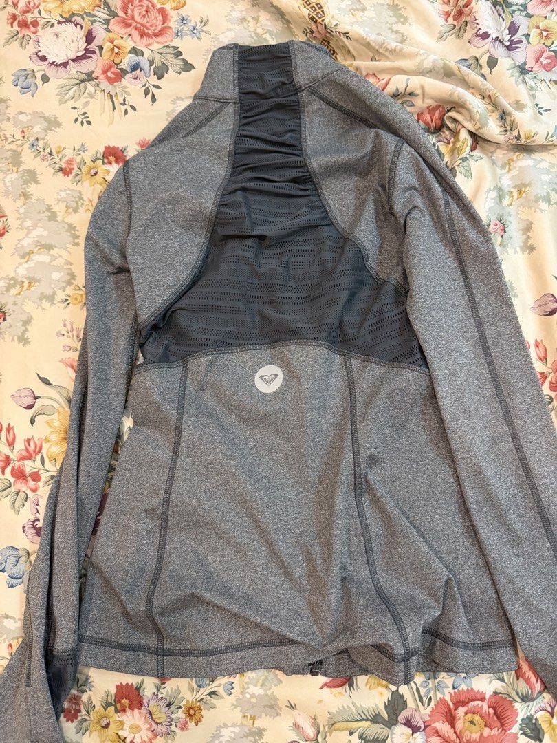 Roxy Grey Athletic Zip-Up Jacket (Category: Coats, Jackets and Outerwear) located in Manila. Submitted by bellafleur (Listing ID 1468196757, Image 2). Description: Grey Roxy athletic zip-up jacket in size XS. Breathable mesh panels along the back and sides for extra airflow. Zippered pockets on the front to keep small items secure. Stand-up collar and long sleeves. Lightweight activewear material, great for workouts or morning runs. Made in Indon