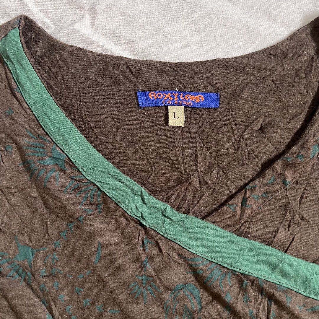 Roxy Lama Patchwork Long Sleeve Top Size L (Category: Longsleeves) located in Manila. Submitted by threadly (Listing ID 1468232349, Image 2). Description: - Brand: Roxy Lama - Size: L (tag attached) - Design: Boho hippie multi-color patchwork (brown, green, maroon, and olive tones) - Neckline: V-neck with green trim - Details: Embroidered leaf accents on the chest and spiral stitching near the hem - Sleeves: Unique printed patterns on sleeves and