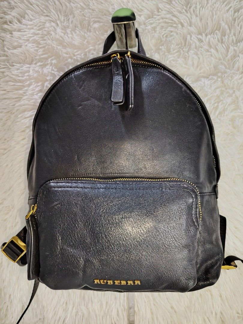 Rubebear Black Leather Backpack with Gold Zippers (Category: Backpacks) located in Quezon City. Submitted by zhelcloset01 (Listing ID 1468081561, Image 1). Description: - Brand: Rubebear - Color: Black with chic gold hardware - Material: Supple textured leather - Storage: Double-zip main compartment and front zip pocket - Comfort: Adjustable straps for a custom fit - Condition: Clean interior with normal wear on the exterior leather surface - Ver