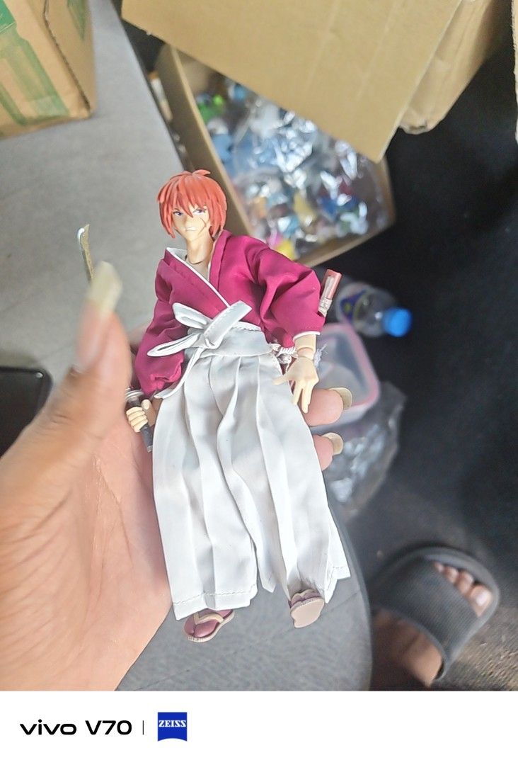 Rurouni Kenshin Action Figure Set (Category: Figurines & Statues) located in Kapangan. Submitted by ClumZyDale (Listing ID 1468135155, Image 3). Description: - Set of 2 authentic Rurouni Kenshin action figures - Detailed red kimono and white hakama outfits - Includes miniature sword accessories - Fully articulated joints for dynamic posing - Comes with official display bases featuring copyright markings.