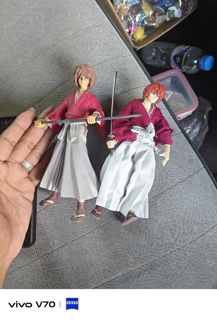 Rurouni Kenshin Action Figure Set (Category: Figurines & Statues) located in Kapangan. Submitted by ClumZyDale (Listing ID 1468135155, Image 1). Description: - Set of 2 authentic Rurouni Kenshin action figures - Detailed red kimono and white hakama outfits - Includes miniature sword accessories - Fully articulated joints for dynamic posing - Comes with official display bases featuring copyright markings.