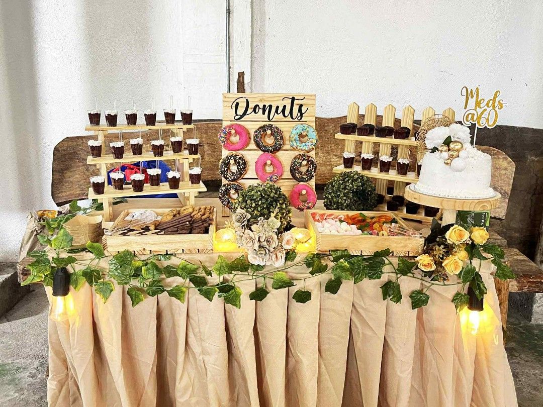 Rustic wooden dessert table display set with stands and decor (Category: Tables & Sets) located in Angono. Submitted by mrallstuff (Listing ID 1468253653, Image 1). Description: - Complete rustic wooden dessert table setup bundle - Includes tiered dessert stands, donut display board, wooden pastry trays, and cake stand - Comes with artificial greenery and fairy light vines for decoration - Sturdy wooden pieces featuring a beautiful natural grain 