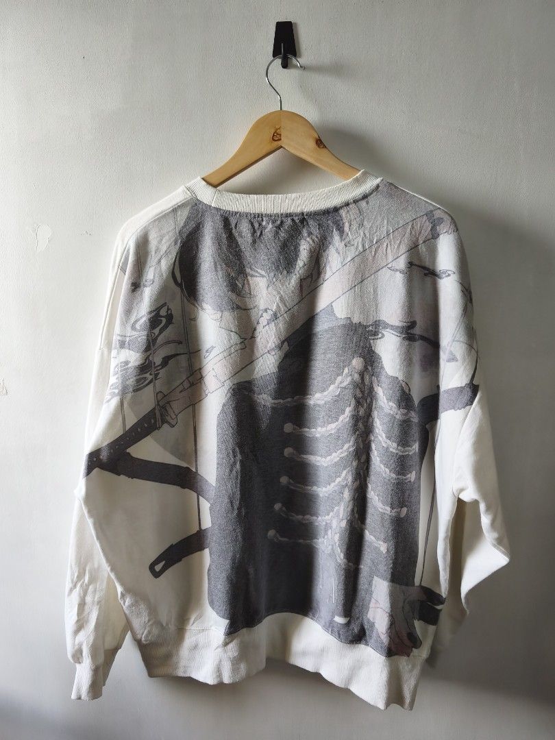 SAKUSYA2 Sweatshirt White Code B5 (Category: Coats, Jackets and Outerwear) located in Manila. Submitted by gelog2 (Listing ID 1468144858, Image 2). Description: - Brand: SAKUSYA2 - Color: White - Code: B5 - Size: Length 27, Width 23 - Design: Small front chest logo, large detailed skeleton and sword back graphic - Details: Ribbed cuffs and hem, soft fabric - Condition: 9.5/10, clean and excellent look.