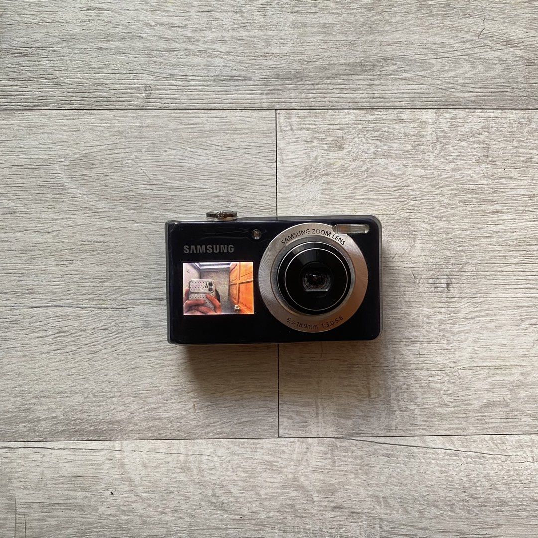 Samsung PL100 Digital Camera (Category: Cameras) located in Bacoor. Submitted by sneakypics.ph (Listing ID 1468174274, Image 1). Description: ୨୧ Samsung PL100 in Black [ Dual Screen ] 🖤 ₱2,499 php ੈ✩ Details [ Maganda pa shots neto guys! ] • 12.2MP CCD Sensor • 3x Optical Zoom Samsung Lens • 35mm Wide-Angle Lens • 2.7” Main LCD Display • 1.5” Front LCD Display for Selfies • VGA Video Recording • Digital Image Stabilization • Smart Auto Mode • Be