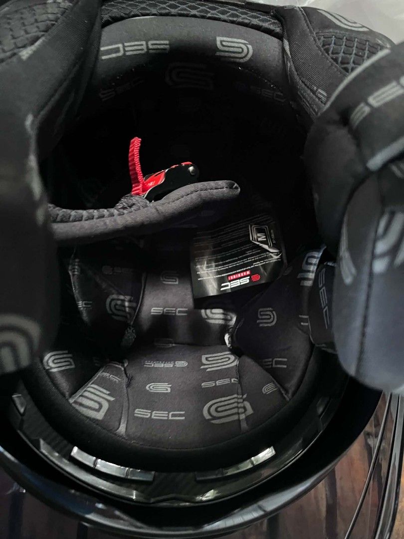 SEC Matte Black Half Face Motorcycle Helmet Size M (Category: Bicycles) located in Manila. Submitted by mr.panda1118 (Listing ID 1468124825, Image 3). Description: - Brand: SEC - Style: Matte black modular helmet with carbon fiber pattern accents - Size: Medium (57-58cm) with fully lined SEC branded padding - Visor: Includes a clear outer shield and built-in internal sun visor - Packaging: Comes complete in its original box - Condition: Excellent