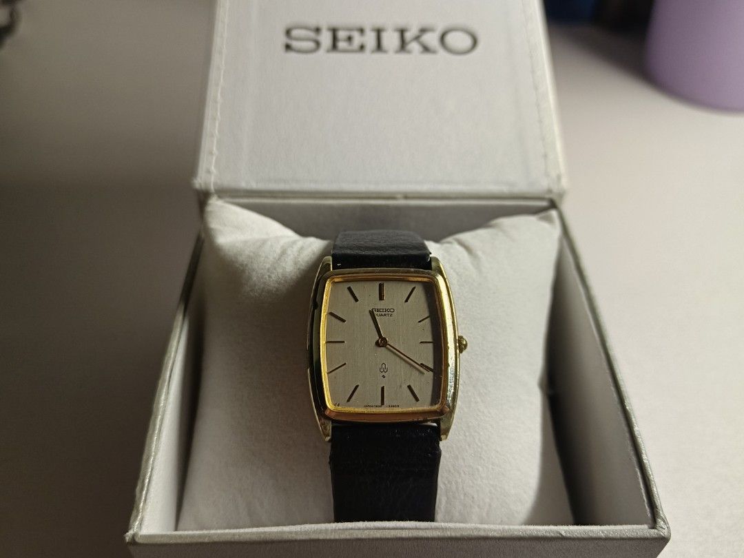 Seiko Tank Unisex (Category: Women's Watches) located in Manila. Submitted by warmdeer.4acc73 (Listing ID 1468240776, Image 2). Description: - Brand: Seiko Quartz - Style: Classic dress watch - Design: Gold-tone rectangular case with a silver textured dial - Strap: Black leather strap - Condition: Keeps good time, with minor signs of wear on the gold plating around the bezel edges - Inclusion: Comes in an original white Seiko watch box with a cus