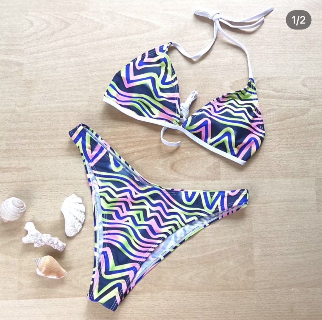 SHEIN Abstract Wave Print Bikini Set Size L (Category: Bikinis & Swimsuits) located in Bulacan. Submitted by peach1025 (Listing ID 1468102660, Image 1). Description: - Brand: SHEIN - Condition: Brand new with tag attached, never worn - Size: L - Design: Blue base with vibrant neon green, pink, and purple abstract wave pattern - Top: Triangle halter style with adjustable tie strings and removable padding inserts - Bottoms: Matching high-leg cut - 