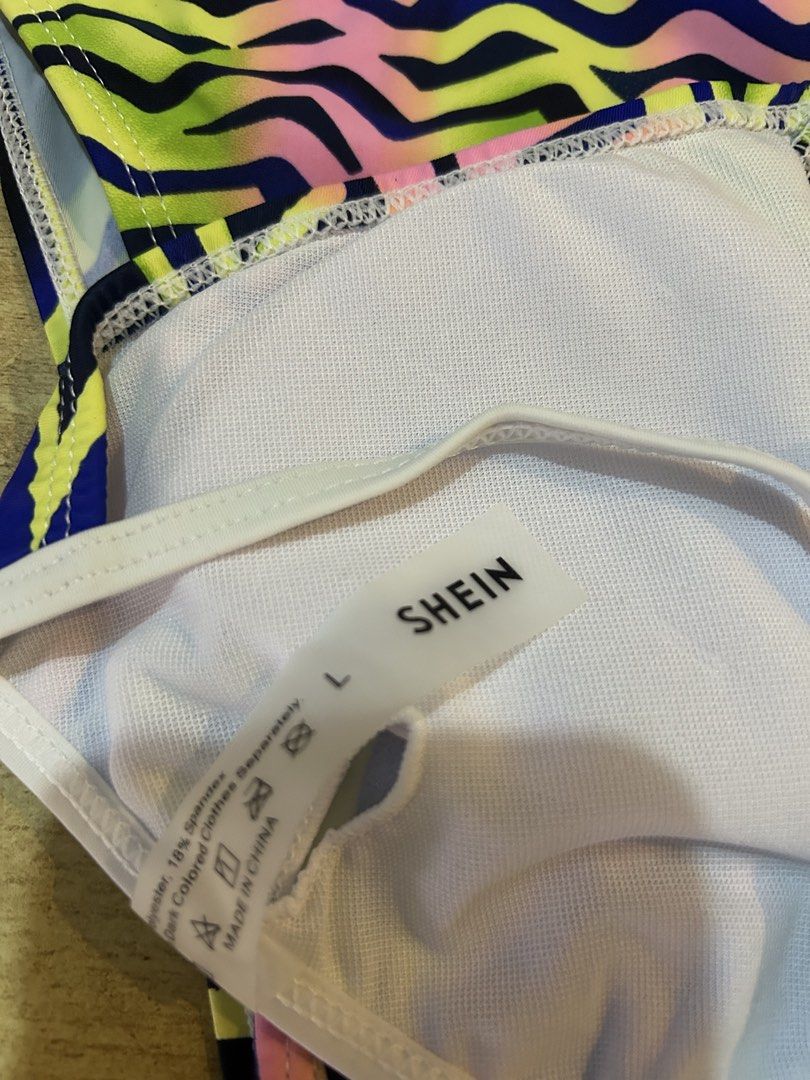 SHEIN Abstract Wave Print Bikini Set Size L (Category: Bikinis & Swimsuits) located in Bulacan. Submitted by peach1025 (Listing ID 1468102660, Image 3). Description: - Brand: SHEIN - Condition: Brand new with tag attached, never worn - Size: L - Design: Blue base with vibrant neon green, pink, and purple abstract wave pattern - Top: Triangle halter style with adjustable tie strings and removable padding inserts - Bottoms: Matching high-leg cut - 