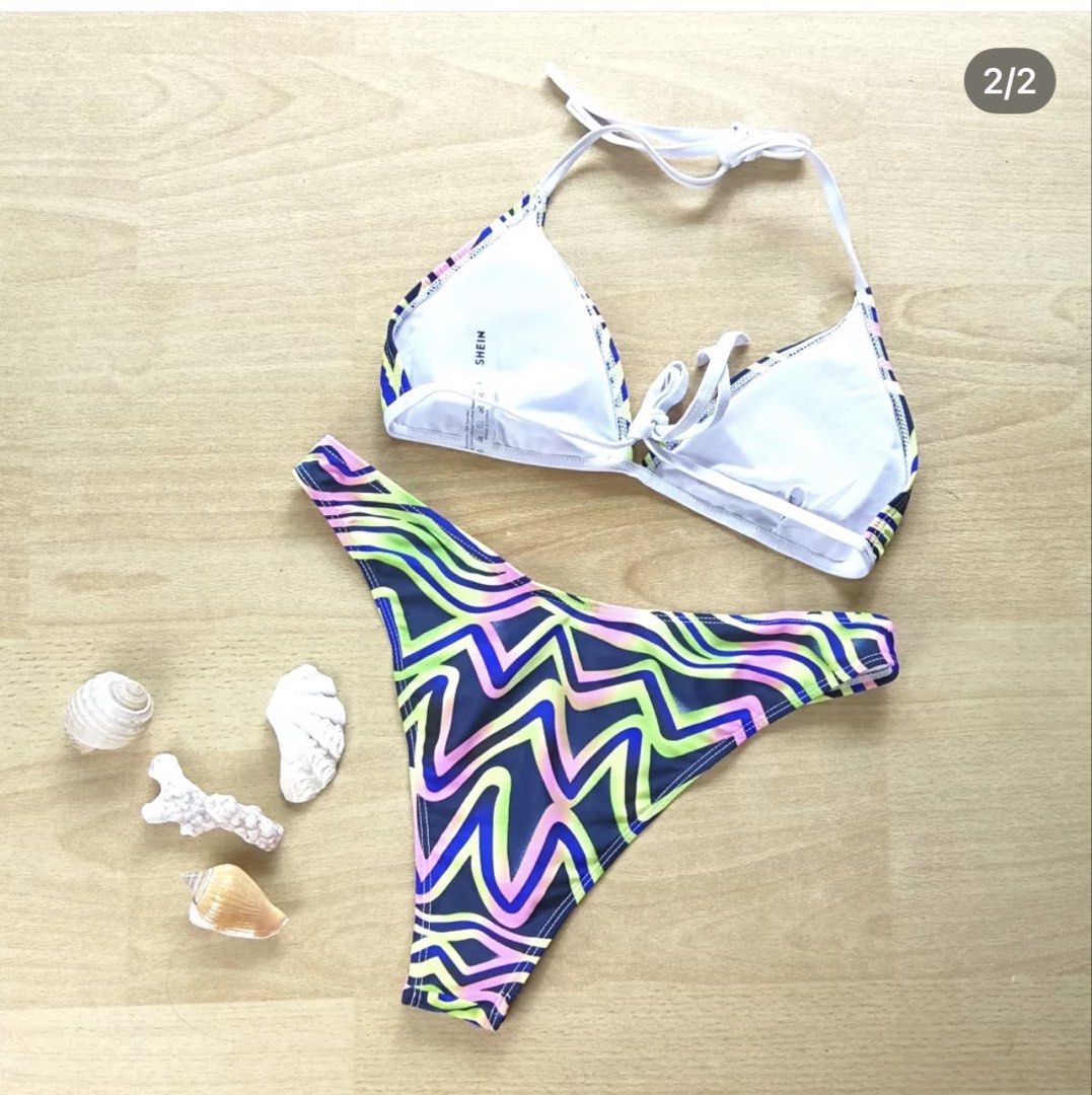 SHEIN Abstract Wave Print Bikini Set Size L (Category: Bikinis & Swimsuits) located in Bulacan. Submitted by peach1025 (Listing ID 1468102660, Image 2). Description: - Brand: SHEIN - Condition: Brand new with tag attached, never worn - Size: L - Design: Blue base with vibrant neon green, pink, and purple abstract wave pattern - Top: Triangle halter style with adjustable tie strings and removable padding inserts - Bottoms: Matching high-leg cut - 