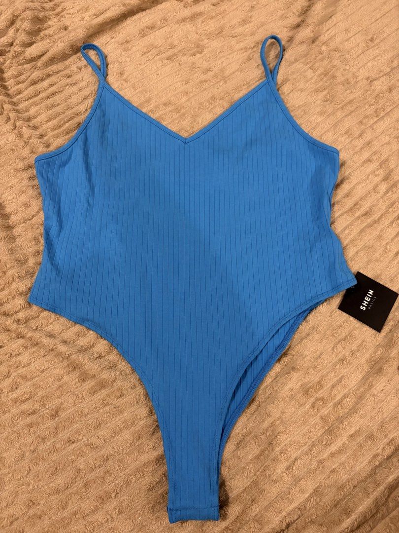 SHEIN Basics Blue Ribbed Bodysuit (Category: Sleeveless) located in Quezon City. Submitted by nadz.b (Listing ID 1468117370, Image 1). Description: - Brand: SHEIN Basics - Color: Bright blue - Material: Ribbed fabric - Design: V-neck with thin spaghetti straps and high-cut leg style - Condition: Brand new with original tag attached.