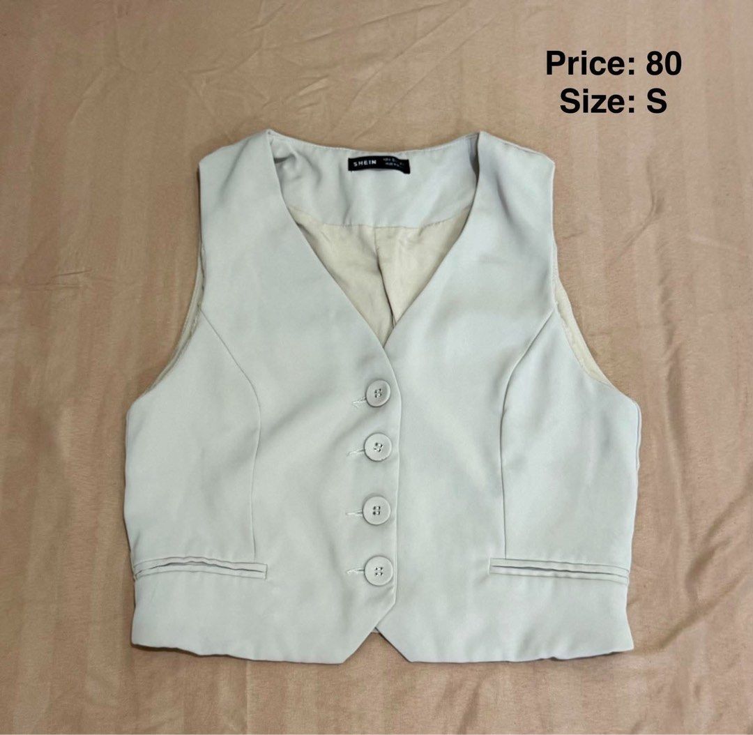 Beige Cropped Button Vest Size S (Category: Sleeveless) located in Makati City. Submitted by shanineee (Listing ID 1468116351, Image 1). Description: - Brand: SHEIN - Size: Small (S) - Color: Classic Beige - Design: V-neckline with 4 matching front buttons - Details: Functional front welt pockets, fully lined interior, and a flattering cropped hem - Style Tip: Great layering piece for smart casual and office- siren outfits.