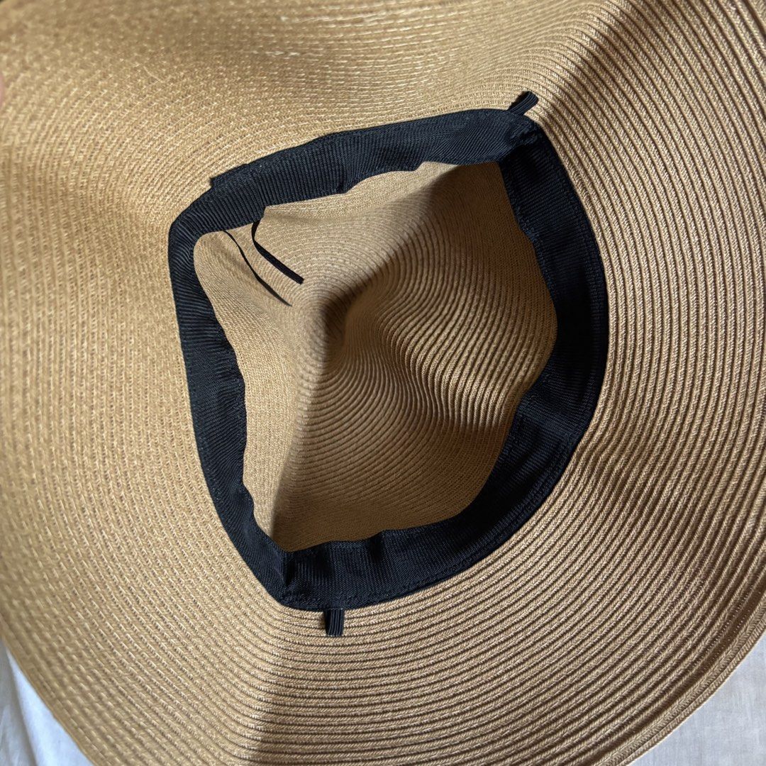 Shein Beige Rafia Sun Hat (Category: Hats & Beanies) located in Binan City. Submitted by myprelovedhaul (Listing ID 1468071798, Image 3). Description: The image shows a tan or beige straw/rafia sun hat featuring a wide brim and a gathered metallic/satin ribbon band adorned with small sparkling or dotted accents.